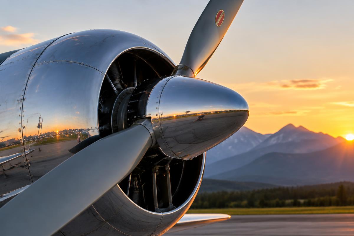 Polished aircraft propeller and cowling at sunrise